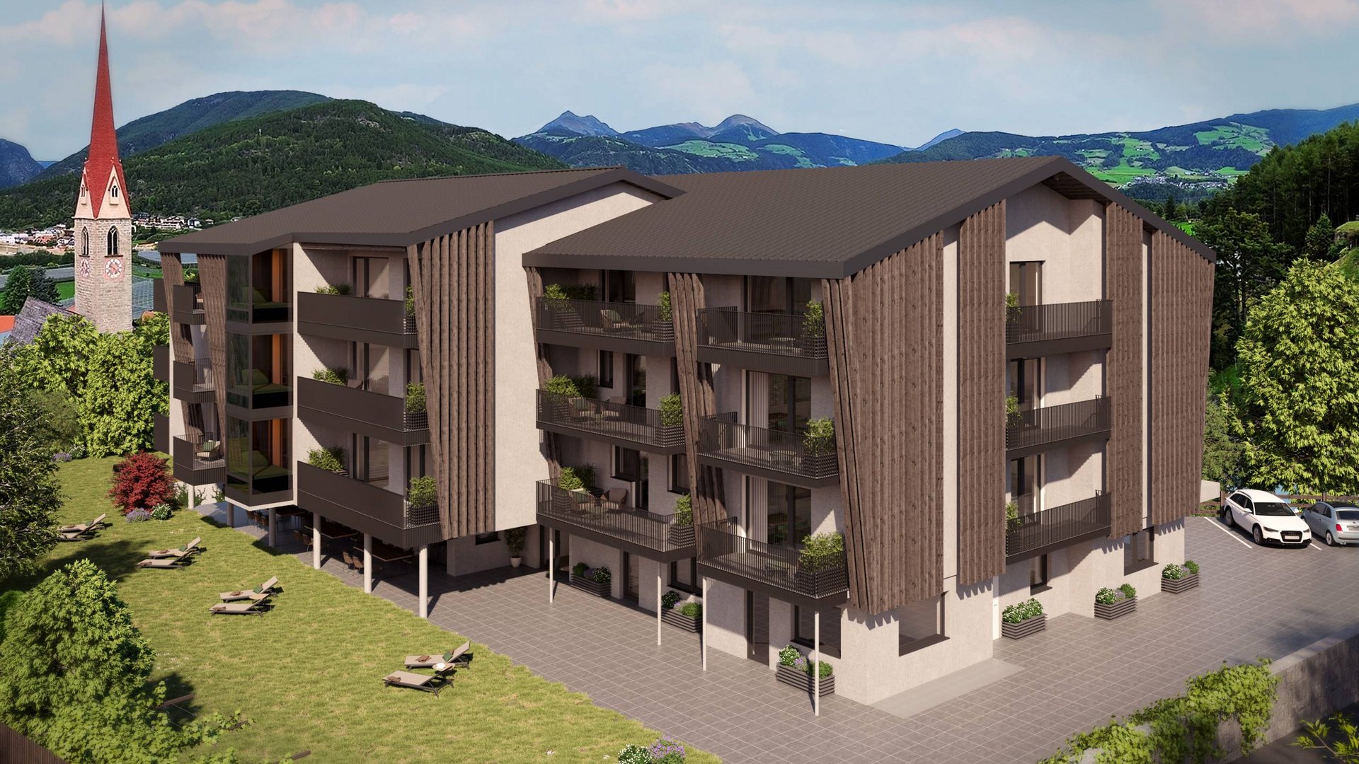 Ihr Hotel in Natz-Schabs bei Brixen, Südtirol Moderner mehrstöckiger Neubau mit Balkonen in einer grünen Berglandschaft